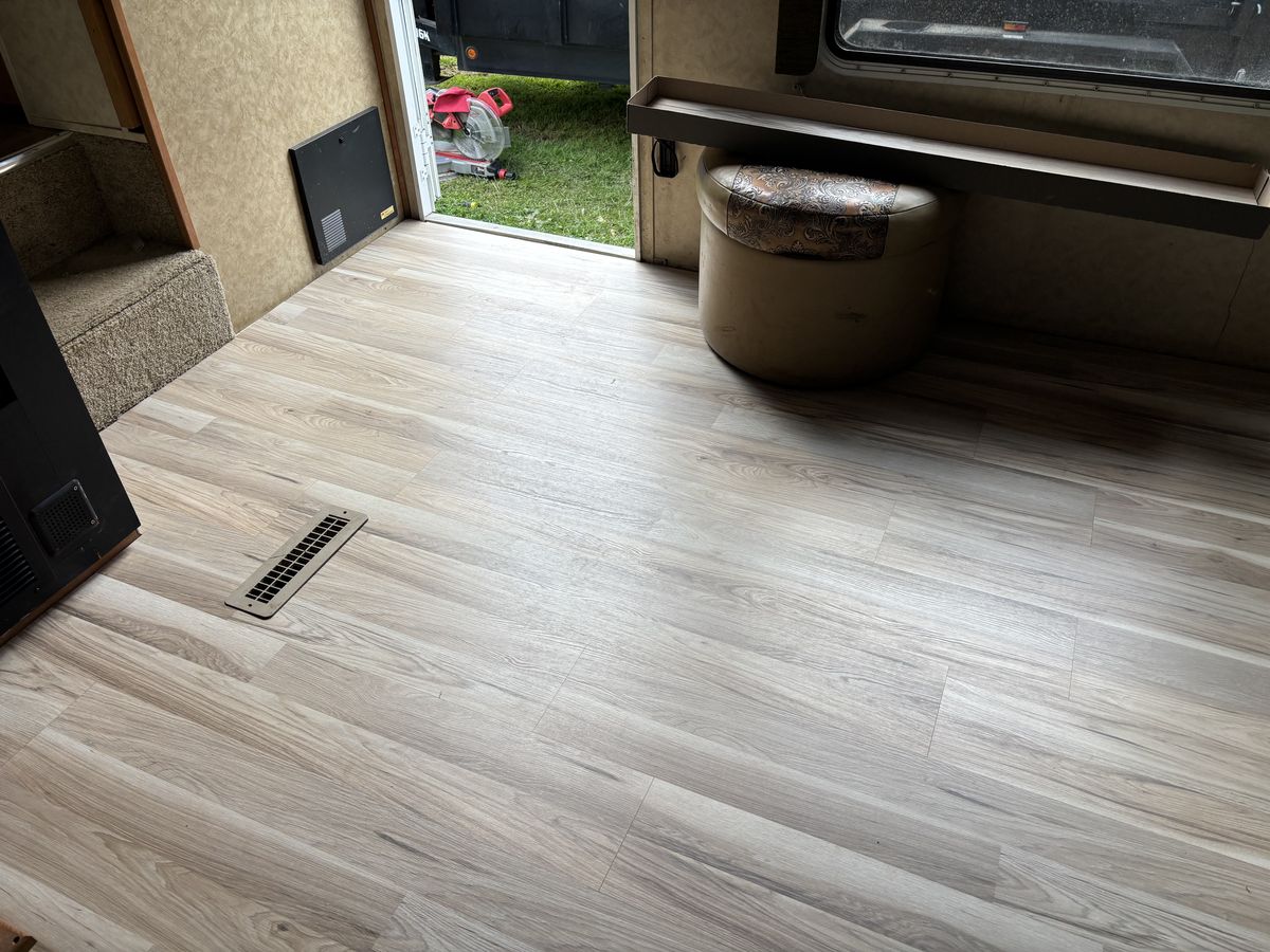 New light-oak vinyl plank flooring installed wall to wall